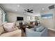 Open-concept living room with stylish furnishings, wood floors, and plenty of natural light at 19111 Whispering Pines Dr, Indian Shores, FL 33785