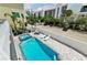 A private pool with a hot tub is surrounded by lush greenery and lounge chairs at 19111 Whispering Pines Dr, Indian Shores, FL 33785