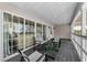 Covered porch with sliding glass doors and comfortable seating ideal for relaxation at 19111 Whispering Pines Dr, Indian Shores, FL 33785