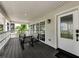 Covered porch with an exterior door leading into the house at 19111 Whispering Pines Dr, Indian Shores, FL 33785