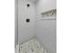 Stylish shower featuring white subway tile, bronze fixtures and a decorative tile mosaic inset at 19111 Whispering Pines Dr, Indian Shores, FL 33785