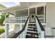 Stairs leading up to the home's entrance and white gravel landscaping at 19111 Whispering Pines Dr, Indian Shores, FL 33785