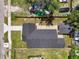 An aerial view of a fenced property with a newly paved driveway and a detached garage at 1914 E Chelsea St, Tampa, FL 33610