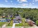 Aerial view of the property showcasing its landscaped yard, modern exterior, and neighborhood surroundings at 1914 E Chelsea St, Tampa, FL 33610