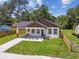 An aerial shot showcases the charming single-story home with fresh landscaping and new walkway and manicured lawn at 1914 E Chelsea St, Tampa, FL 33610