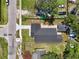 An aerial view of a fenced property with a newly paved driveway and a detached garage at 1914 E Chelsea St, Tampa, FL 33610