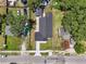 An aerial view of a fenced property with a newly paved driveway and a detached garage at 1914 E Chelsea St, Tampa, FL 33610