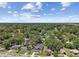 Expansive aerial view featuring property amongst lush green surroundings, highlighting the neighborhood at 1914 E Chelsea St, Tampa, FL 33610