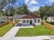 An aerial shot shows a charming home with fresh landscaping, a new walkway, and a newly installed horizontal wood fence at 1914 E Chelsea St, Tampa, FL 33610