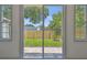 Backyard view through sliding glass doors with stone patio and a wood fence at 1914 E Chelsea St, Tampa, FL 33610
