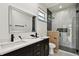 Modern bathroom with double vanity, black accents, and luxurious glass shower at 1914 E Chelsea St, Tampa, FL 33610