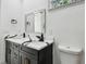 Elegant bathroom featuring a double vanity with marble countertop and black fixtures at 1914 E Chelsea St, Tampa, FL 33610