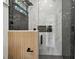 Luxurious glass enclosed shower with wood accent panel and black marble wall at 1914 E Chelsea St, Tampa, FL 33610