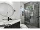Modern bathroom featuring a marble shower, sleek vanity, and contemporary fixtures at 1914 E Chelsea St, Tampa, FL 33610