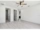 Open bedroom with light gray vinyl flooring and an ensuite bathroom with glass enclosed shower at 1914 E Chelsea St, Tampa, FL 33610