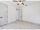 Bedroom featuring two closets, a ceiling fan, neutral paint, and trim at 1914 E Chelsea St, Tampa, FL 33610
