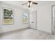 Bright bedroom featuring two windows, a ceiling fan, and a closet at 1914 E Chelsea St, Tampa, FL 33610
