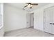 Spacious bedroom with light wood floors, ceiling fan and two doors at 1914 E Chelsea St, Tampa, FL 33610