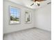 Bright bedroom with light wood floors, ceiling fan and two sunny windows at 1914 E Chelsea St, Tampa, FL 33610