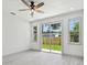 Bright bedroom with backyard view through sliding glass doors and multiple windows at 1914 E Chelsea St, Tampa, FL 33610