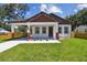 Beautiful home boasting a cozy front porch, neatly arranged landscaping, and architectural details at 1914 E Chelsea St, Tampa, FL 33610