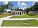 Inviting home showcasing a convenient carport, well-kept lawn, and tidy wooden fencing at 1914 E Chelsea St, Tampa, FL 33610