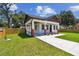 Quaint home with a convenient carport, colorful flower accents, and a well-manicured lawn at 1914 E Chelsea St, Tampa, FL 33610