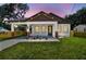Charming home featuring a welcoming front porch, manicured lawn, and red brick accents at 1914 E Chelsea St, Tampa, FL 33610