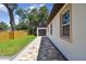 Home exterior with stone paver path leading to the detached garage and a new wooden fence at 1914 E Chelsea St, Tampa, FL 33610