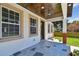 Charming front porch with a unique patterned floor, complemented by fresh landscaping at 1914 E Chelsea St, Tampa, FL 33610