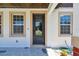Front porch featuring decorative tiles, white stucco, and a modern front door at 1914 E Chelsea St, Tampa, FL 33610