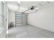 Spacious two car garage featuring epoxy floor and bright lighting at 1914 E Chelsea St, Tampa, FL 33610