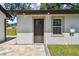 Exterior view of the detached garage door and newly installed paver patio at 1914 E Chelsea St, Tampa, FL 33610