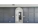 Hallway with decorative wall molding and an arched doorway leading into the Primary bathroom at 1914 E Chelsea St, Tampa, FL 33610