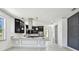 Open kitchen with stainless appliances, contrasting cabinets, and marble countertops at 1914 E Chelsea St, Tampa, FL 33610