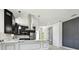 Modern kitchen with stainless appliances, contrasting cabinets, and marble countertops at 1914 E Chelsea St, Tampa, FL 33610