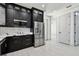 Modern kitchen with stainless steel appliances and black cabinets with gold hardware and eat in space at 1914 E Chelsea St, Tampa, FL 33610