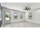 Bright living room with a ceiling fan, lots of natural light, and ceramic tile flooring at 1914 E Chelsea St, Tampa, FL 33610