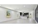 Bright, open-concept living area connecting to modern kitchen with stainless steel appliances at 1914 E Chelsea St, Tampa, FL 33610