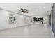 Bright living room featuring a ceiling fan, neutral paint, tile floors, and an open layout to the kitchen at 1914 E Chelsea St, Tampa, FL 33610