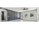 Bright living room showcasing paneled accent wall, modern ceiling fan, and gleaming hardwood floors at 1914 E Chelsea St, Tampa, FL 33610