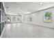 Bright and spacious living room with hardwood floors and many windows and doorways at 1914 E Chelsea St, Tampa, FL 33610