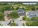Aerial view of a home with a three-car garage, large yard and mature trees at 21108 Bircholm Ct, Land O Lakes, FL 34637