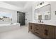 Bright bathroom features a double vanity, a soaking tub, and a glass enclosed shower at 21108 Bircholm Ct, Land O Lakes, FL 34637