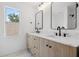 Bathroom featuring dual sinks and decorative mirrors at 21108 Bircholm Ct, Land O Lakes, FL 34637