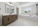 Bright bathroom features a double vanity, a soaking tub, and a glass enclosed shower at 21108 Bircholm Ct, Land O Lakes, FL 34637