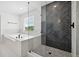 The glass shower is tiled with a herringbone pattern next to a soaking tub at 21108 Bircholm Ct, Land O Lakes, FL 34637