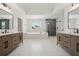 Large bathroom with dual sink vanities, soaking tub, walk-in shower, and modern fixtures at 21108 Bircholm Ct, Land O Lakes, FL 34637