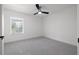 A standard empty bedroom space with carpet and a ceiling fan at 21108 Bircholm Ct, Land O Lakes, FL 34637