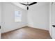 Bright bedroom with natural light, hardwood floors, and a contemporary ceiling fan at 21108 Bircholm Ct, Land O Lakes, FL 34637